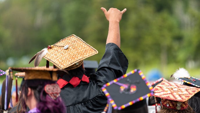 A person wearing a graduation cap and gown

AI-generated content may be incorrect.