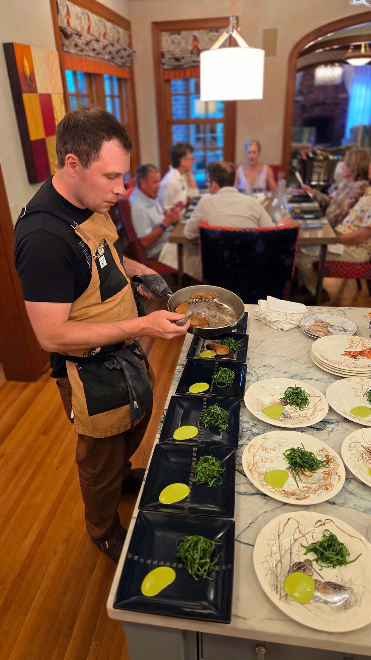 Alan Bergo plating fish for the dinner. Alan Bergo plating fish for the dinner.