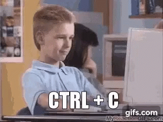 a young boy is sitting at a desk in front of a computer with the words `` ctrl + c '' written on the screen . a young boy is sitting at a desk in front of a computer with the words `` ctrl + c '' written on the screen .