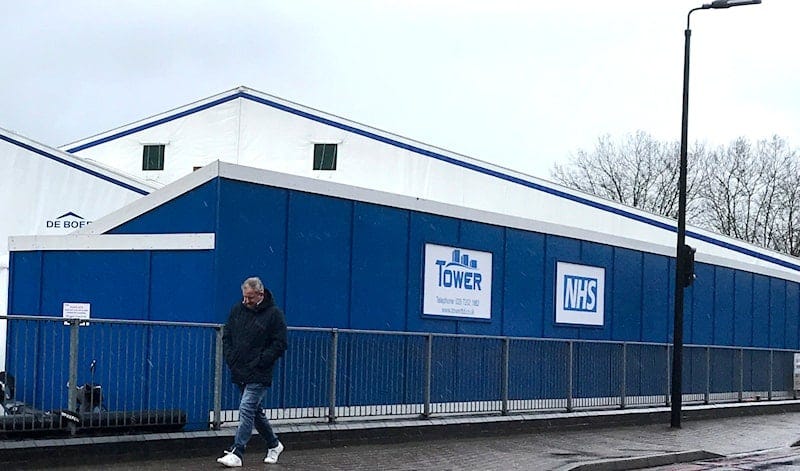 A pedestrian passes a COVID testing facility that has been set up at St.George's Hospital in London, Tuesday, Jan. 4, 2022. (AP Photo/Kirsty Wigglesworth) A pedestrian passes a COVID testing facility that has been set up at St.George's Hospital in London, Tuesday, Jan. 4, 2022. (AP Photo/Kirsty Wigglesworth)