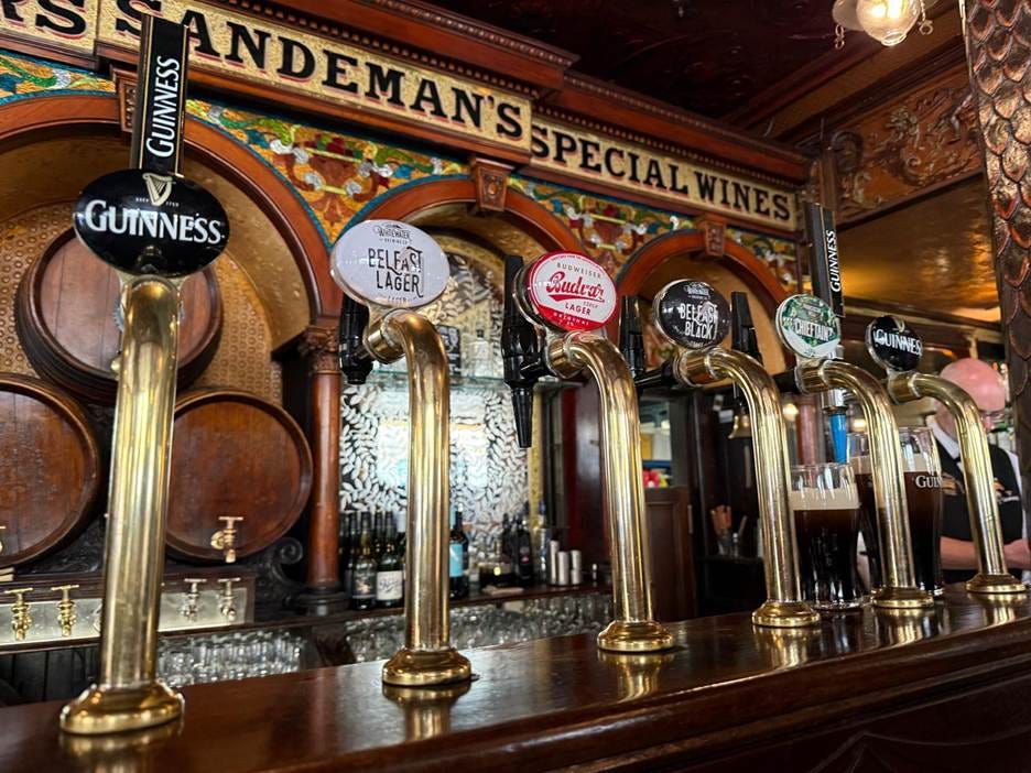 A row of beer taps in a bar

AI-generated content may be incorrect.