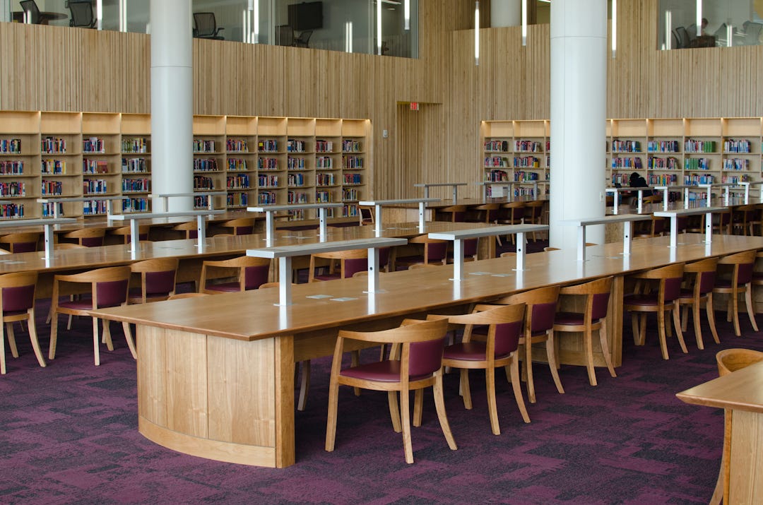 Rows of Hunt Chairs line up behind custom study tables on oval-shaped pedestal bases. Rows of Hunt Chairs line up behind custom study tables on oval-shaped pedestal bases.
