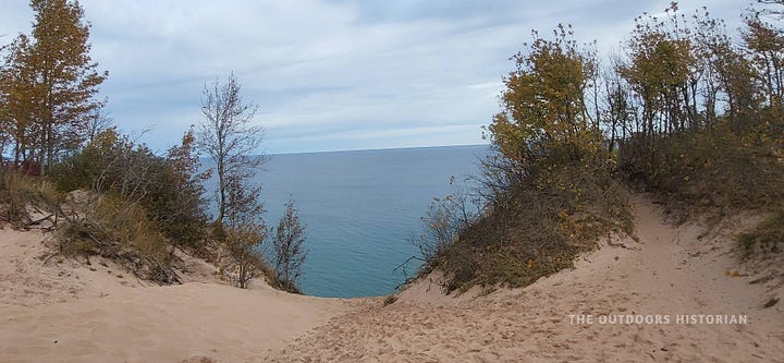 A panoramic view of the massive sand dunes at Pictured Rocks, paired with a photo from the top of the Log Slide looking down toward the blue water of Lake Superior.