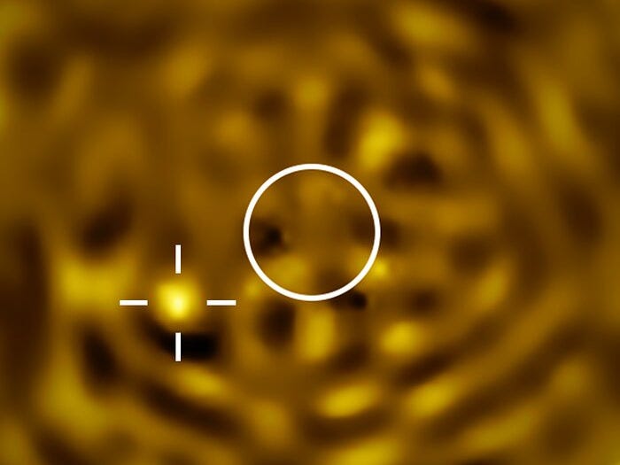 A telescopic image of Betelgeuse’s companion. The image is filled with a noisy pattern of bright and dark features, but there is a particularly bright object towards the lower-left. A white circle at the centre of the image indicates the size of Betelgeuse, which has been removed. A telescopic image of Betelgeuse’s companion. The image is filled with a noisy pattern of bright and dark features, but there is a particularly bright object towards the lower-left. A white circle at the centre of the image indicates the size of Betelgeuse, which has been removed.