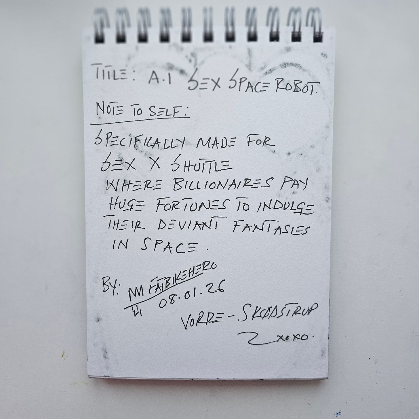 Handwritten notes by artist FatbikeHero on a spiral-bound sketchbook page. The text reads "Title: A.I Sex Space Robot" and describes a "Sex X Shuttle" for billionaires to indulge fantasies in space. Signed and dated 08.01.26, Vorre-Skødstrup.
