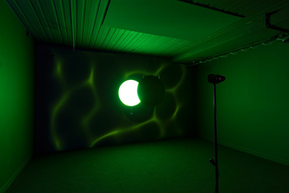'Imperial Eclipse of War', round lightbox, hanging perspex, video projection, stereoscope, 2017. Photography by Matthew Stanton. 'Imperial Eclipse of War', round lightbox, hanging perspex, video projection, stereoscope, 2017. Photography by Matthew Stanton.