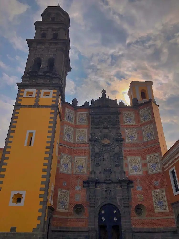 Church with yellow tower and red facade
