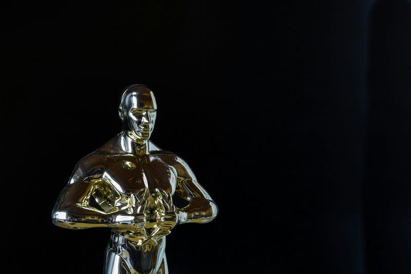 An Oscar award with a black background