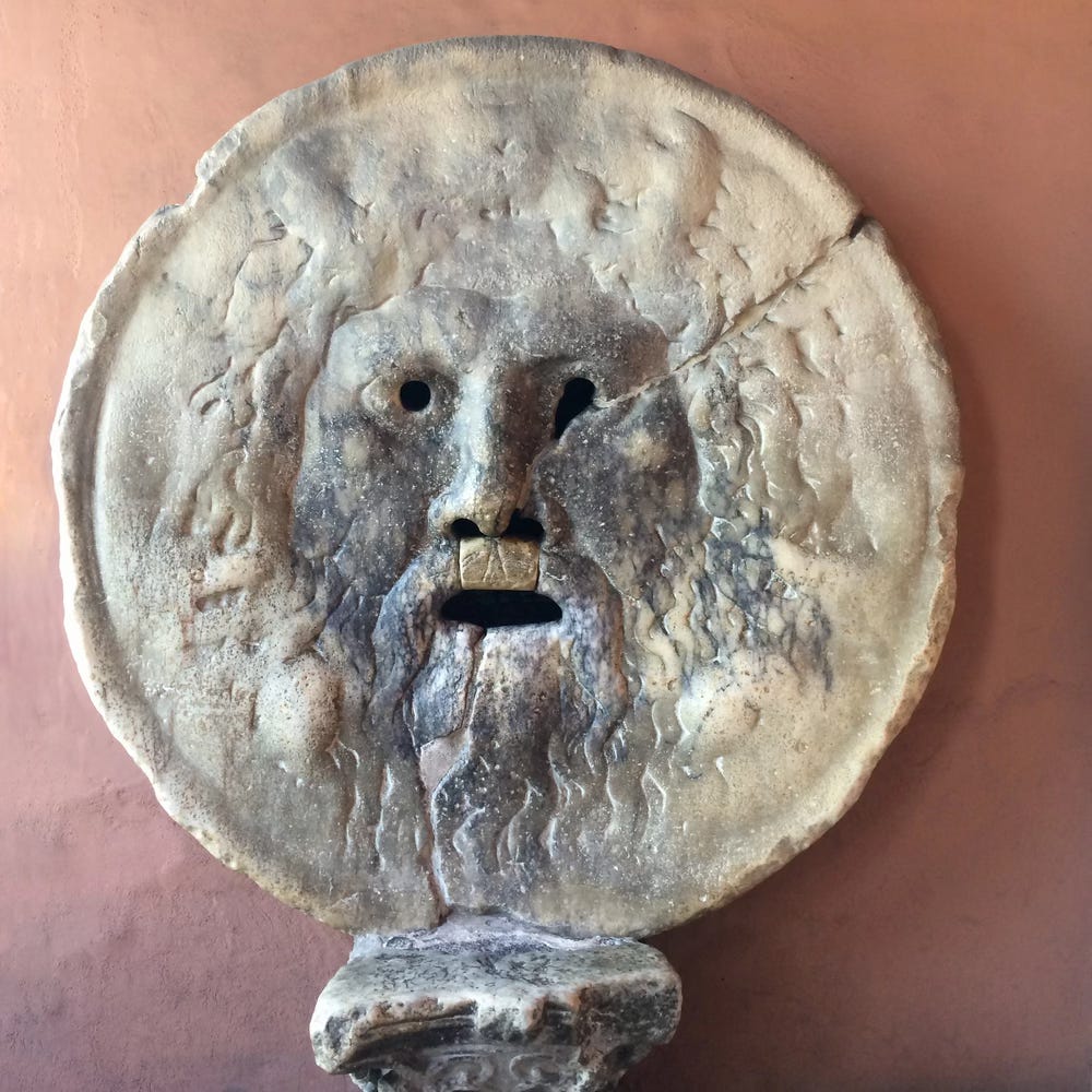 Large carved marble disk with a face and cut through mouth and eyes Large carved marble disk with a face and cut through mouth and eyes