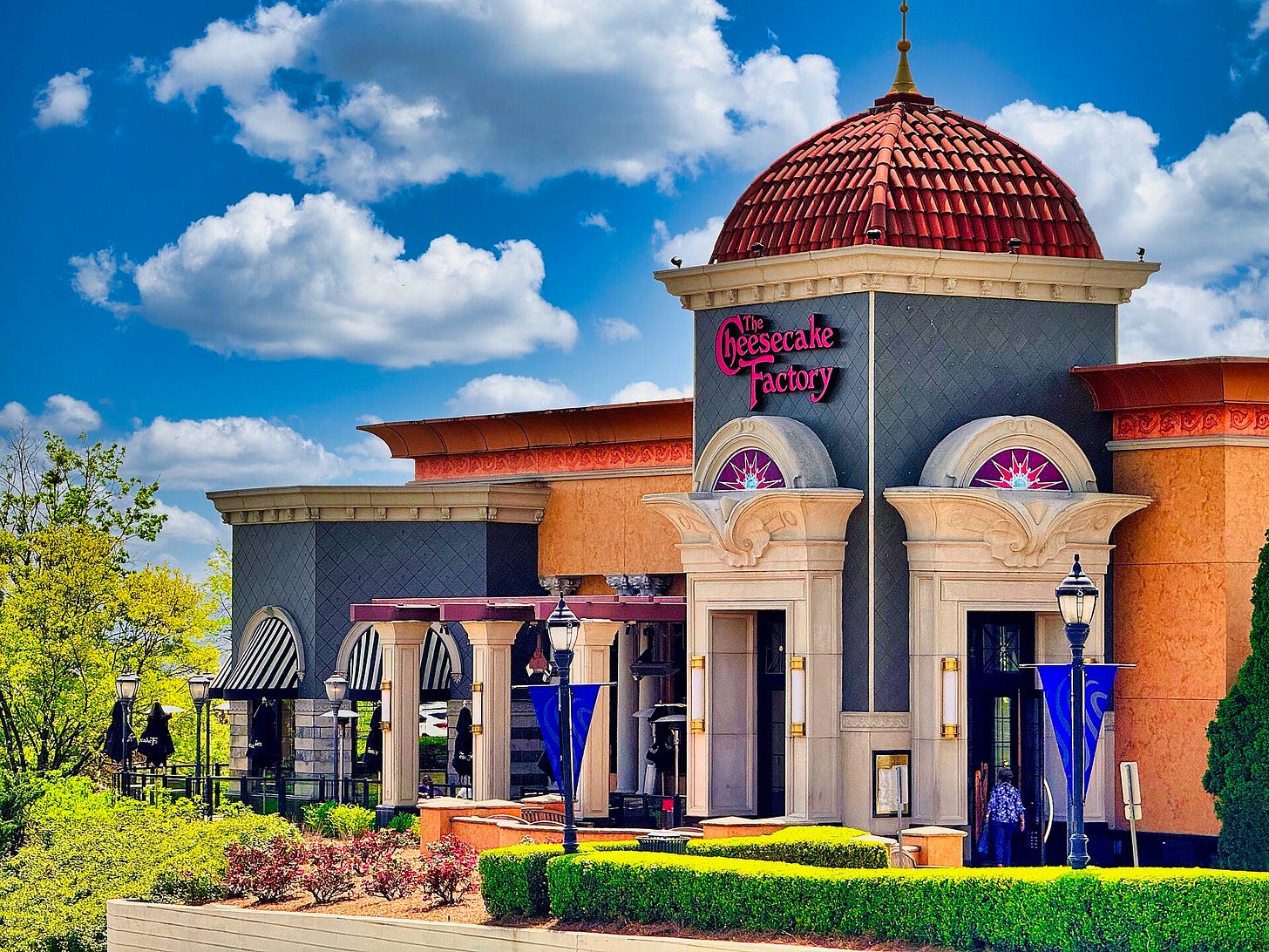 outdoor view of really garish cheesecake factory in orange and blue