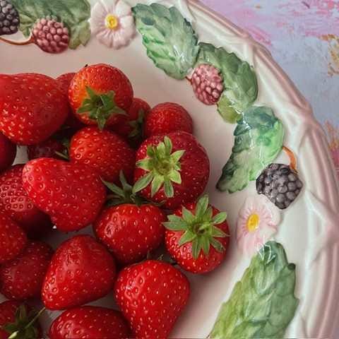 Vintage fruit strainer with strawberries