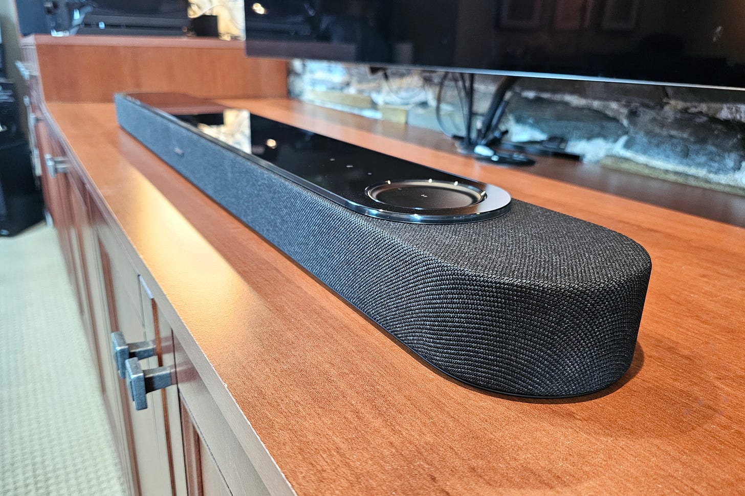 The Bose Lifestyle Ultra Soundbar seen on a media counter surface from a right angle.