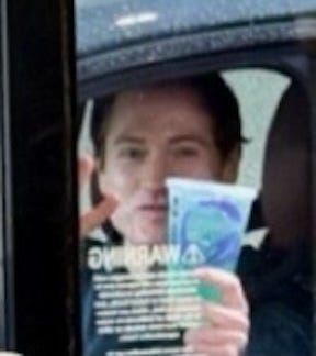 An even closer zoom of the man in the drive-thru window