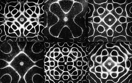 white sand forms six chladni figures of varying complexity on black metal plates white sand forms six chladni figures of varying complexity on black metal plates
