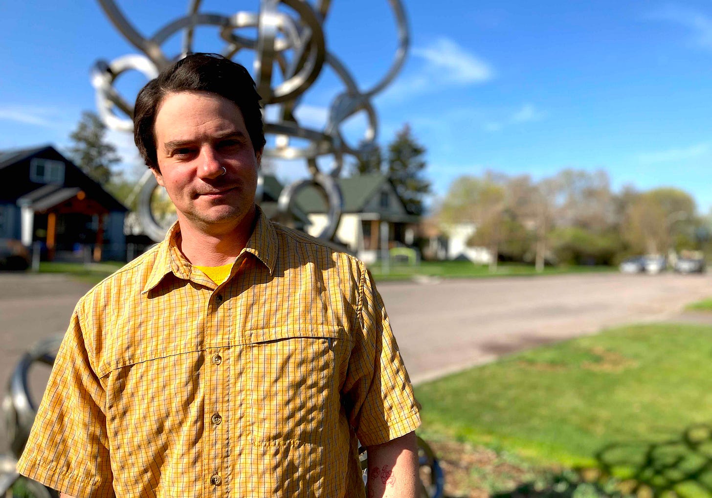 man in yellow shirt outside on sunny morning