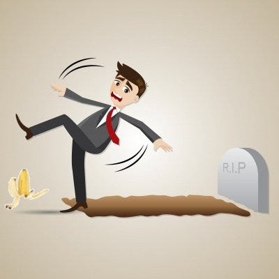 Man standing with one foot in a grave and slipping on a banana peel.