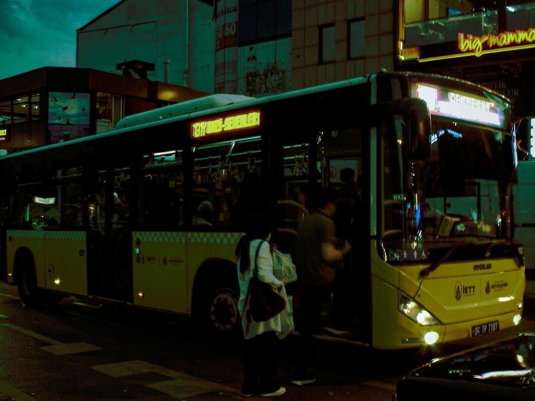 a bus picking up passengers a bus picking up passengers