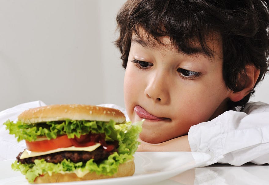A boy looks longingly at a burger, he slicks his lips, ready to eat, I have had the burger, Timβs Grateful 8, Ubiquity A boy looks longingly at a burger, he slicks his lips, ready to eat, I have had the burger, Timβs Grateful 8, Ubiquity