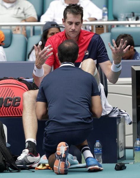 John Isner frustrated by injury at 2019 Miami Open losing to Roger Federer. John Isner frustrated by injury at 2019 Miami Open losing to Roger Federer.