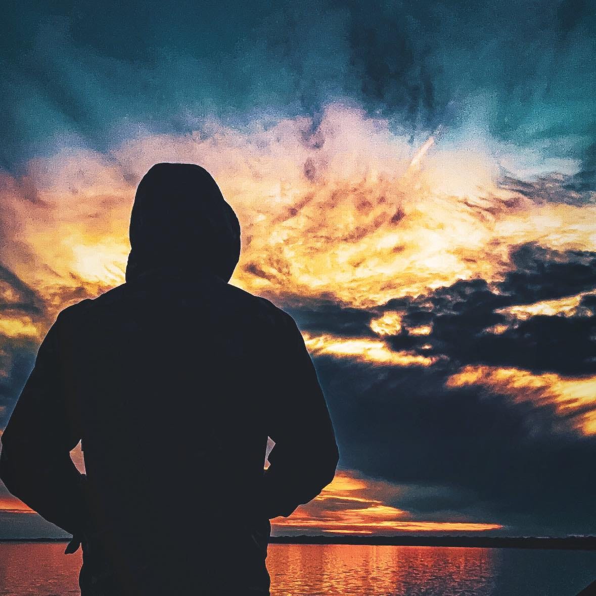 May be an image of 1 person, horizon, twilight and cloud