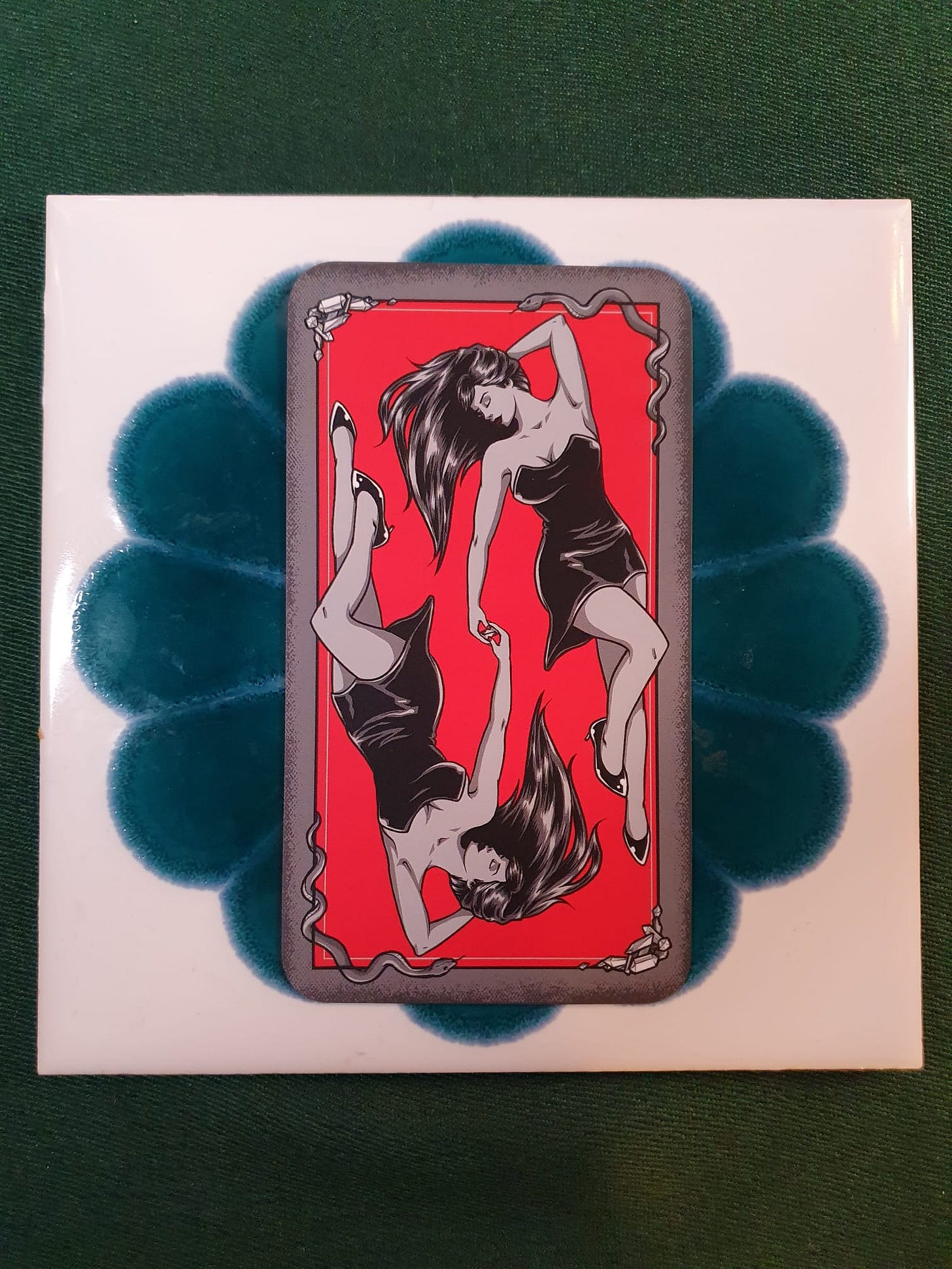Tarot card from Elizabeth Sulis Kim’s Tarot DMs reading, illustrated with two mirrored women in black dresses against a vivid red background. Tarot card from Elizabeth Sulis Kim’s Tarot DMs reading, illustrated with two mirrored women in black dresses against a vivid red background.
