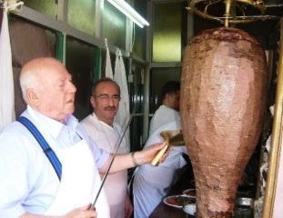 Man slicing up a kebab Man slicing up a kebab