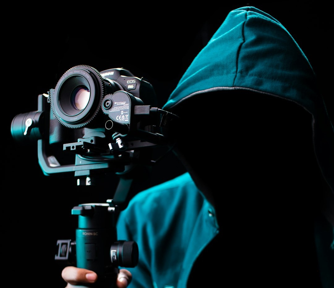 person holding black dslr camera