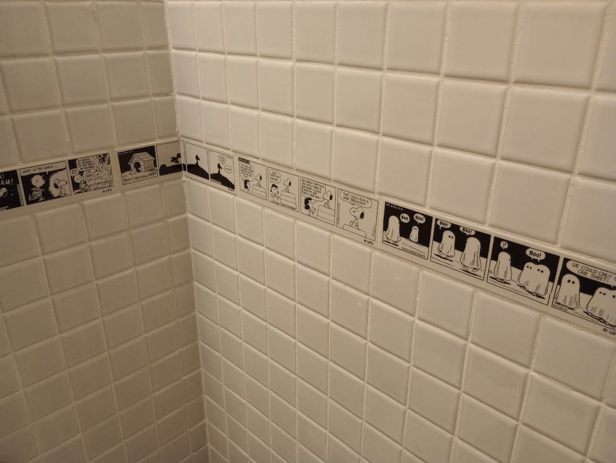 Strip of cartoon tiles built into bathroom wall