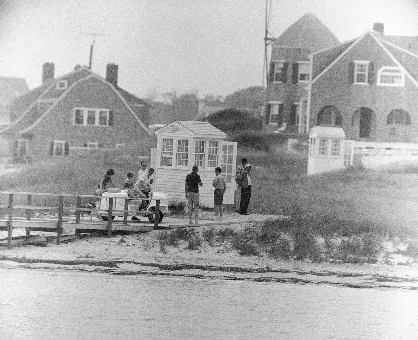 President John F. Kennedy drives a golf cart, taking his family to their summer home after cruising Nantucket Sound aboard the yacht Marlin, Hyannis Port, July 29, 1961.