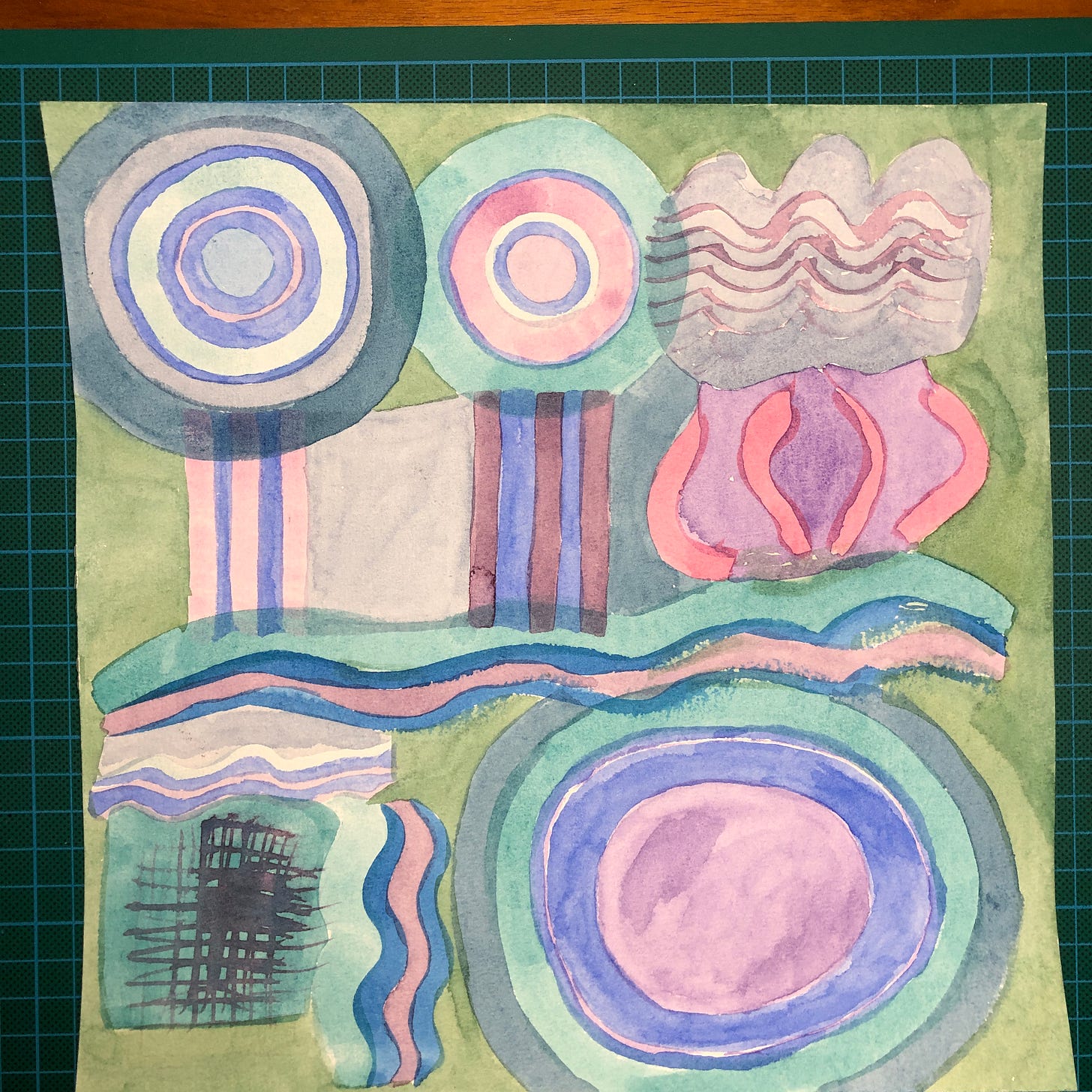 Photo d'une feuille de papier aquarelle sur laquelle sont peintes des formes organiques