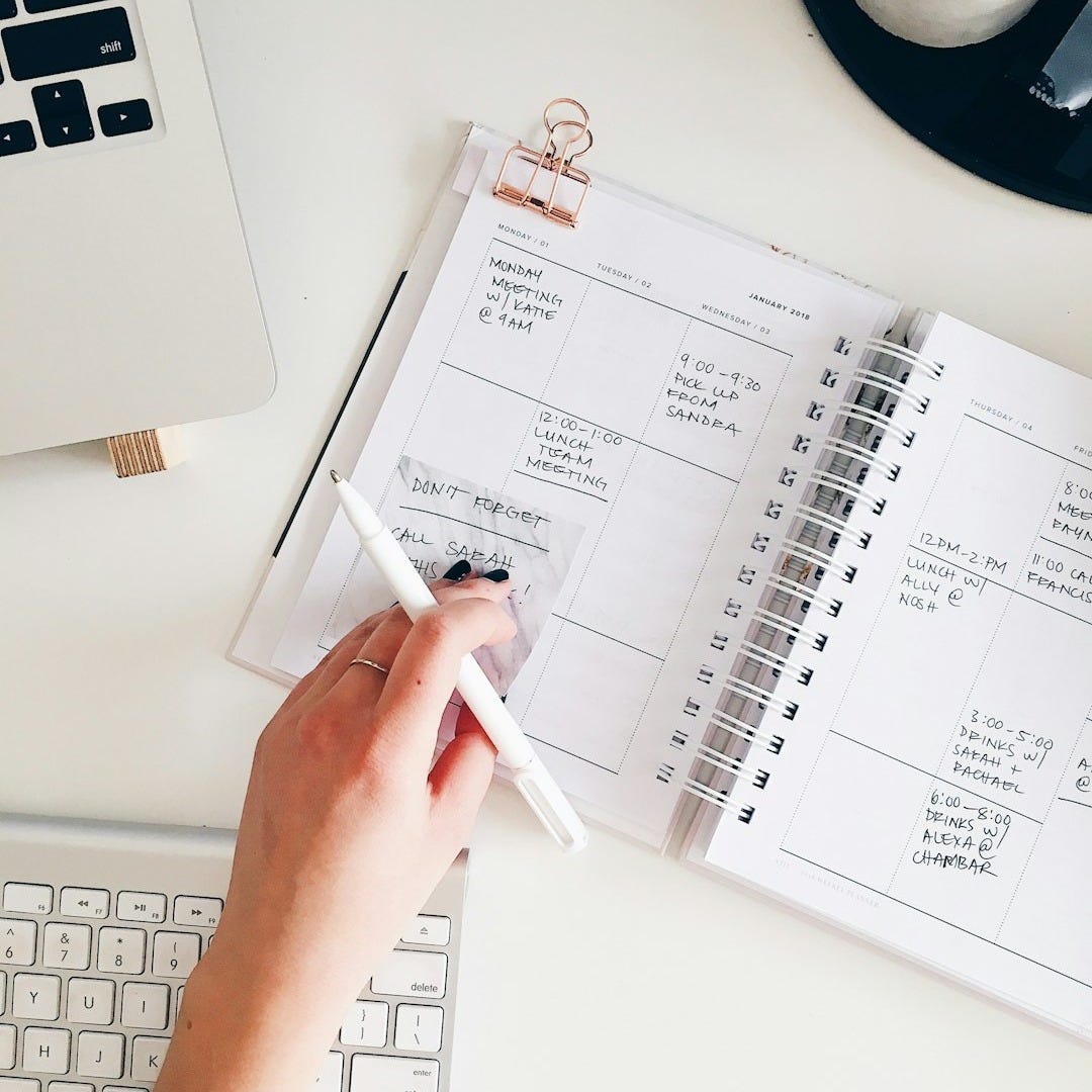 person holding notepad and pen flat lay photography person holding notepad and pen flat lay photography
