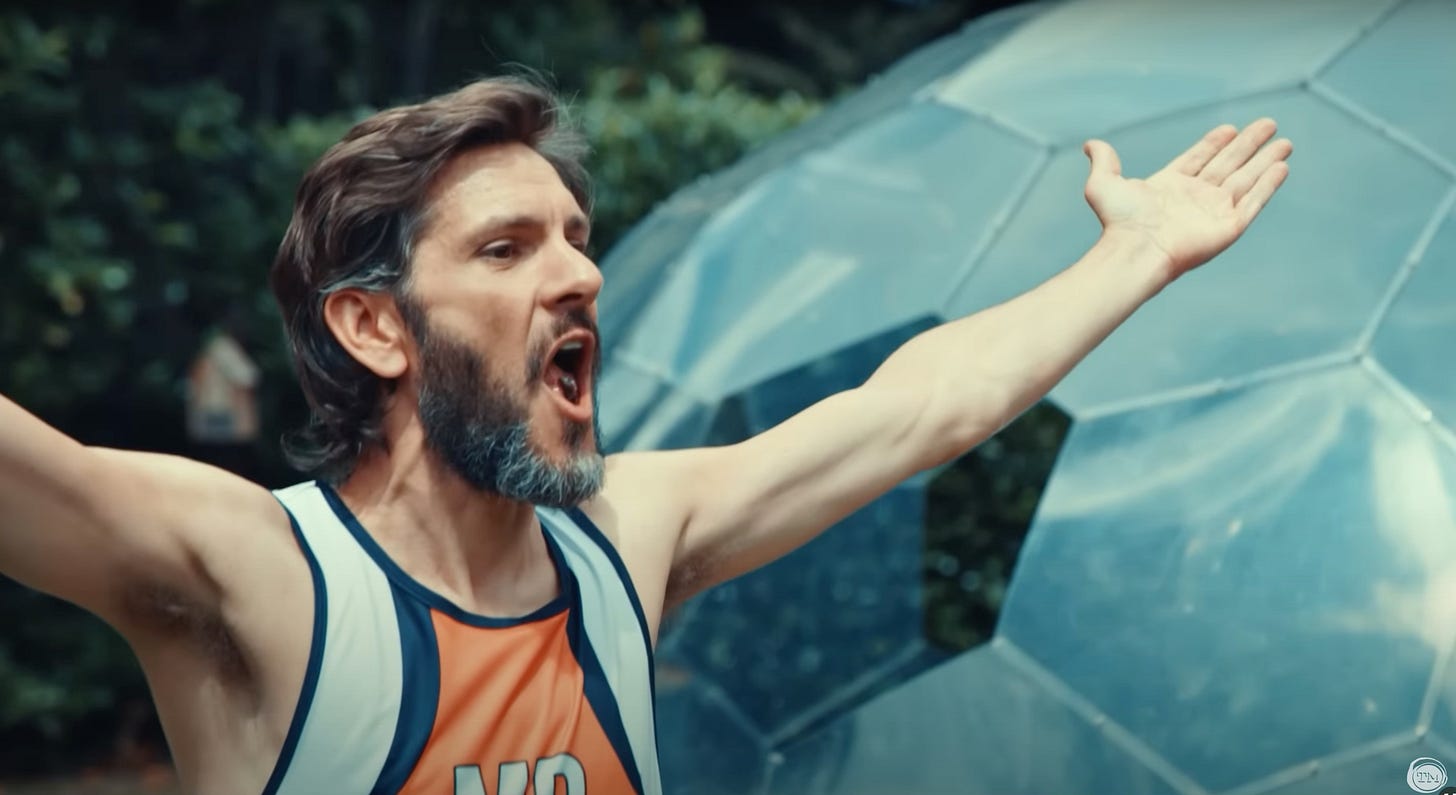 Mathew Baynton catches a grape in his mouth.