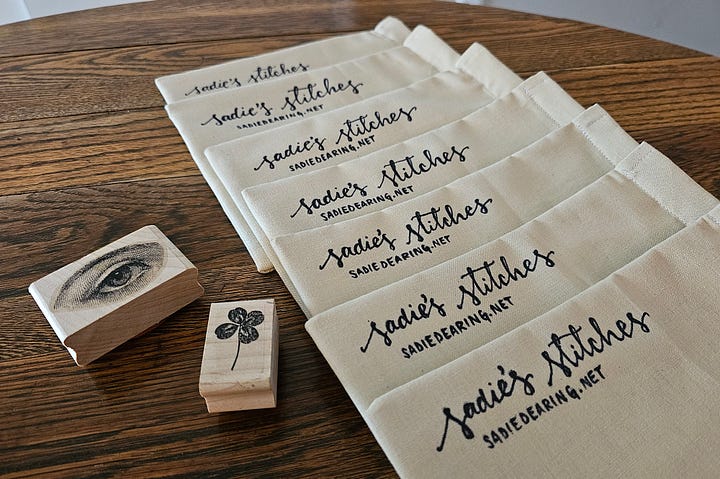 an array of drawstring bags and black ink stamps
