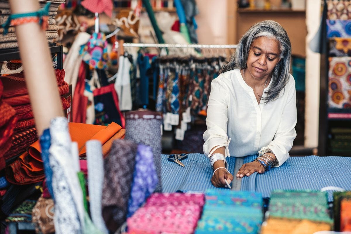 Woman in a textile workshop creating a pattern on cloth