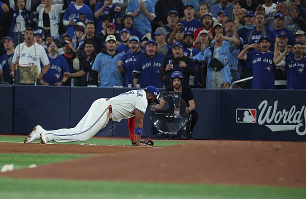 Fans cheer and and first baseman Vladimir Guerrero Jr. Of the Toronto Blue Jays celebrates making a catch on a center fielder Tommy Edman of the Los...