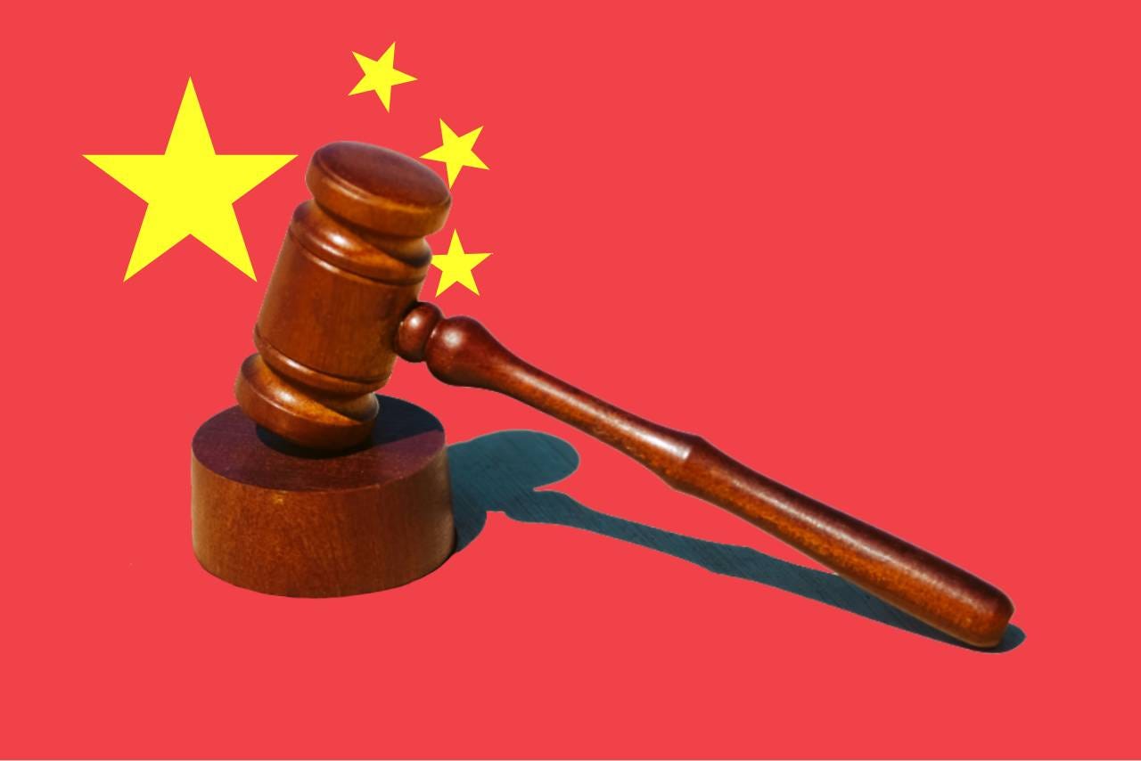 A gavel on a Chinese flag. A gavel on a Chinese flag.