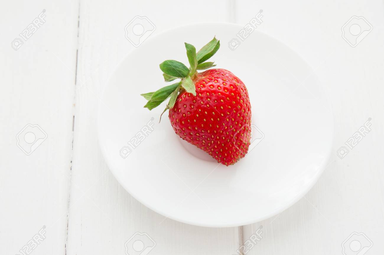 Fresh Single Strawberry In White Plate On The White Wooden Table Stock  Photo, Picture And Royalty Free Image. Image 100611783.