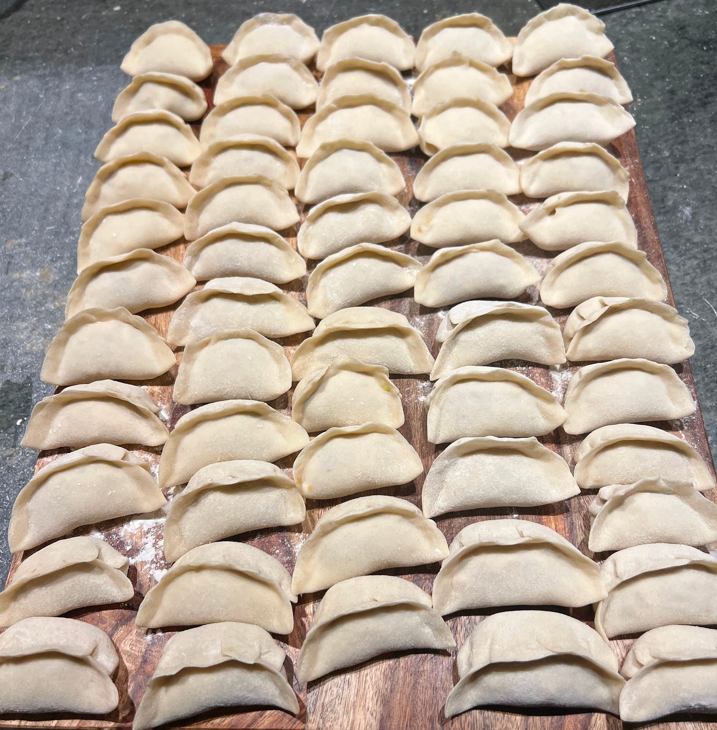 a large tray of freshly made dumplings