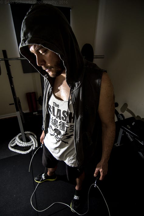 Handsome dude in gym/street clothes working out and posing like a fitness trainer guy