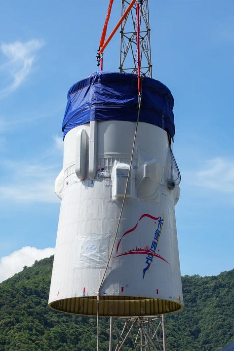 Hardware for the Long March 4C being prepared for launch and being hoisted atop of the vehicle.
