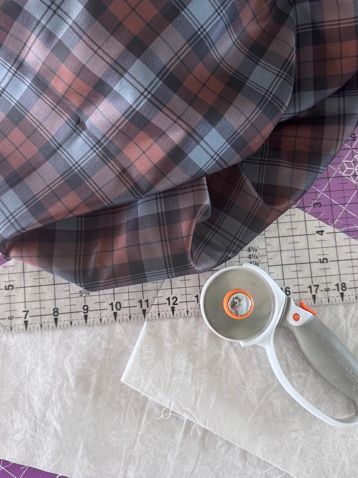 tartan trimmed cross body sash over grey dress