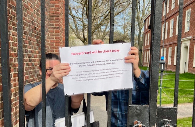 A group of people holding up a sign

Description automatically generated