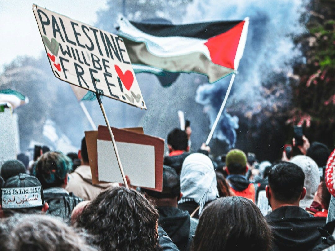 a crowd of people standing around a fire a crowd of people standing around a fire