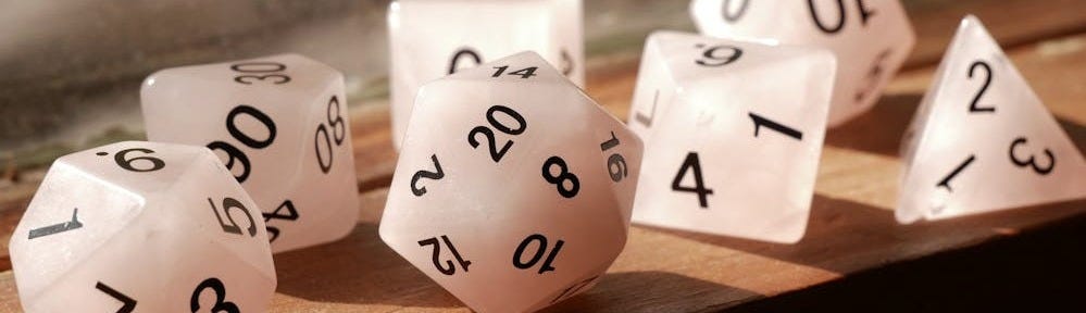 Free High-quality image of polyhedral dice on a wooden surface, perfect for gaming enthusiasts. Stock Photo
