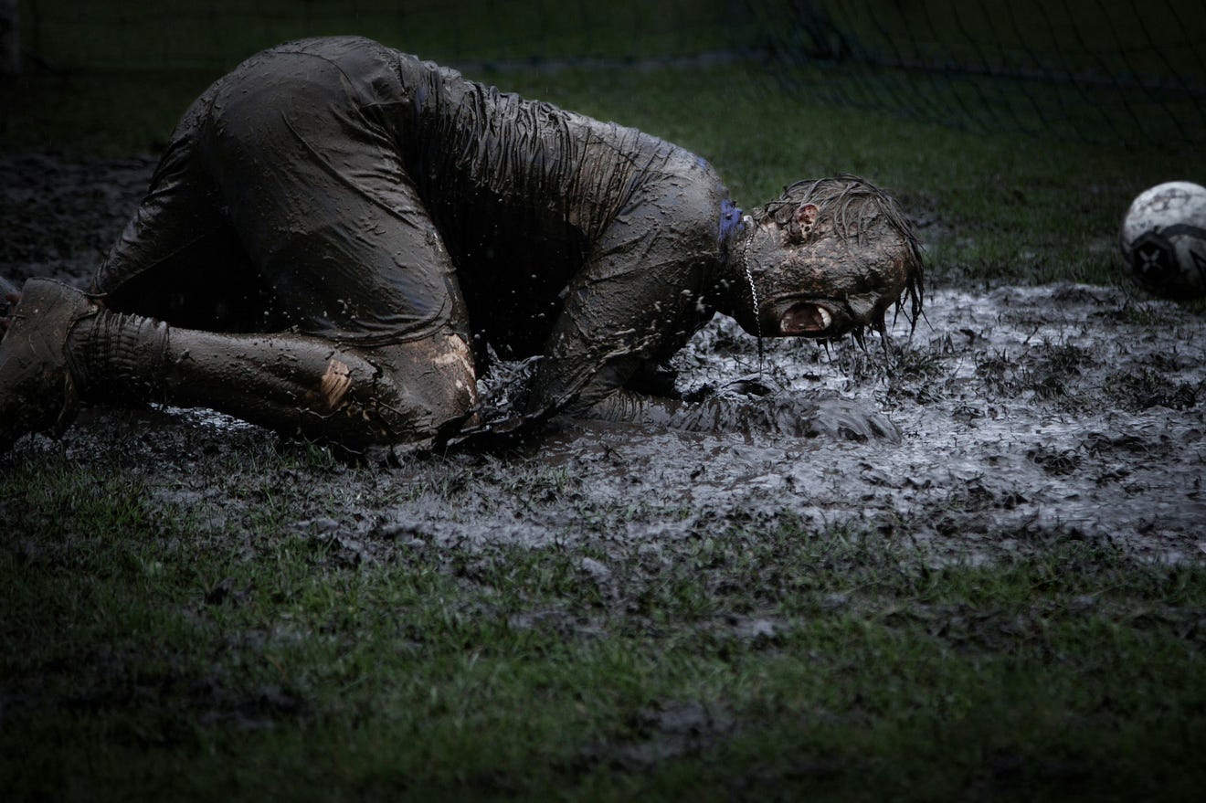 man lying in a pool of mud man lying in a pool of mud