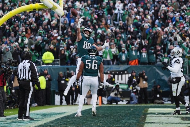Philadelphia Eagles tight end Dallas Goedert (88) celebrates scoring a touchdown with Eagles offensive tackle Tyler Steen during the first half Sunday, Dec. 14, 2025, against the Las Vegas Raiders in Philadelphia. (AP Photo/Matt Rourke)