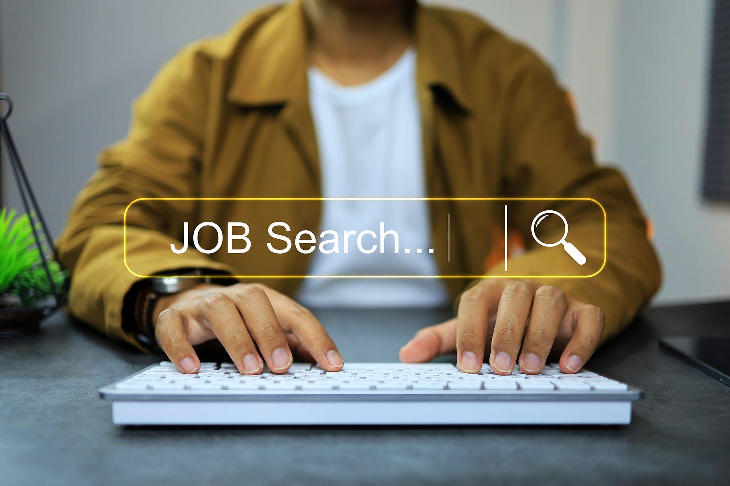 Online job search concept featuring closeup of a person's hands on a keyboard Online job search concept featuring closeup of a person's hands on a keyboard