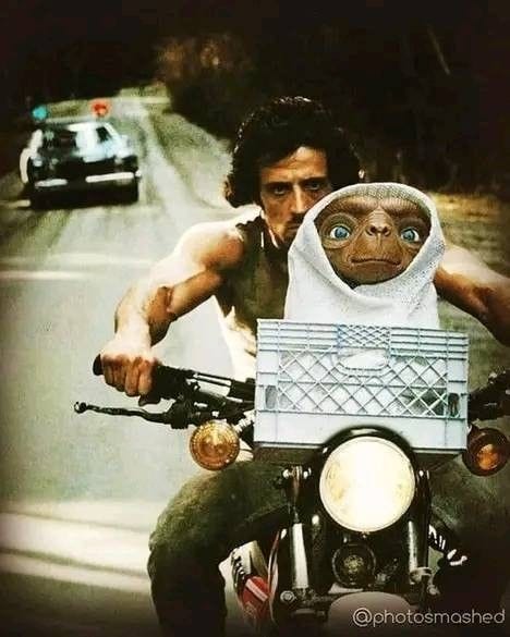 This may contain: a man riding on the back of a motorcycle next to a monkey in a hood