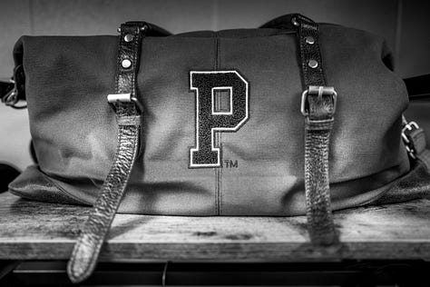bookstore bag with "P" and pom poms, "Y" on ground during dorm bathroom renovations