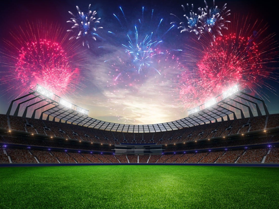 Fireworks fill the night sky at a stadium Fireworks fill the night sky at a stadium